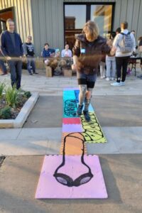 child plays hopscotch on parasite hopscotch tiles