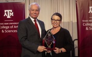 mark zoran and deb bell-pedersen holding award