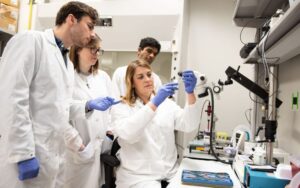 picture of Jen Dulin and her lab members in lab attire