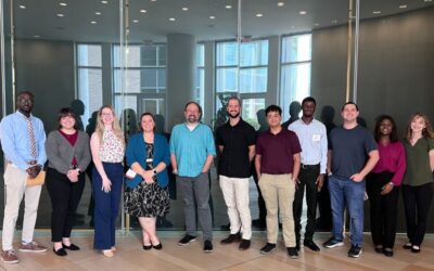 members of sorg lab posing by glass wall