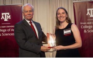 Mark Zoran and McKensie Le Fevre holding award