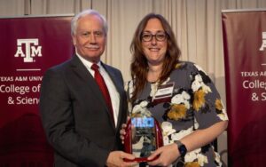 Mark Zoran and Angela Mitchell holding award