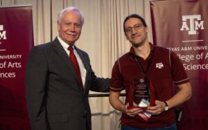 Mark Zoran and Daniel Paredes-Sabja holding award
